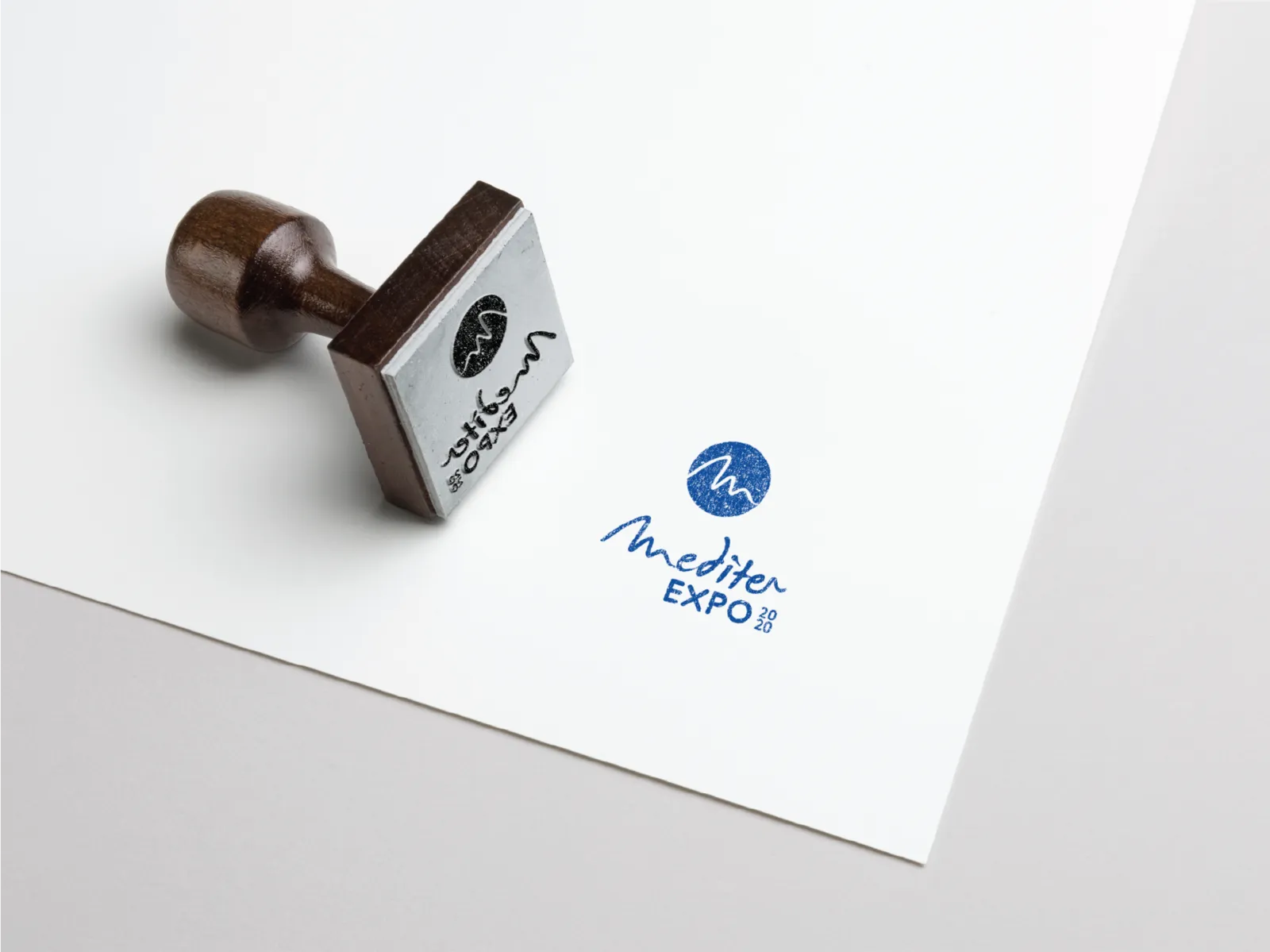 A rubber stamp beside the Mediter Expo logo printed on paper
