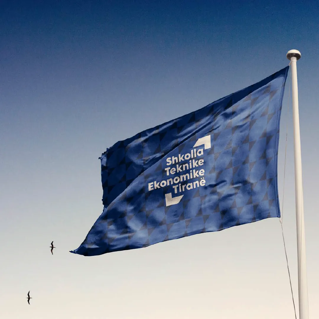 A flag with the word mark against the sky